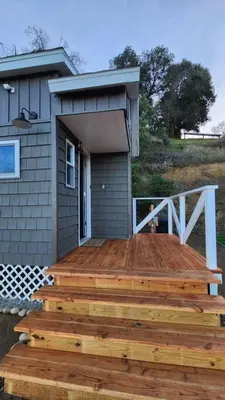 a large wooden deck in front of a house at #13 - The Raven - Tiny Home (Edgar Allan Poe) in Santa Ysabel