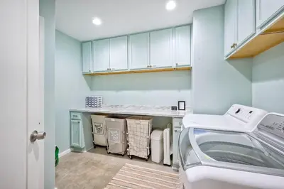 a laundry room with a washer and dryer at City Getaway, Hot Tub, Fire Pit, Game Room, BBQ, Hiking Trails, Vineyard Views, B-Ball in Fallbrook