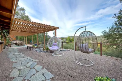 a backyard with two swings and a pavilion at City Getaway, Hot Tub, Fire Pit, Game Room, BBQ, Hiking Trails, Vineyard Views, B-Ball in Fallbrook