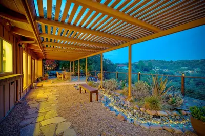 a wooden pergola with a bench on a patio at City Getaway, Hot Tub, Fire Pit, Game Room, BBQ, Hiking Trails, Vineyard Views, B-Ball in Fallbrook