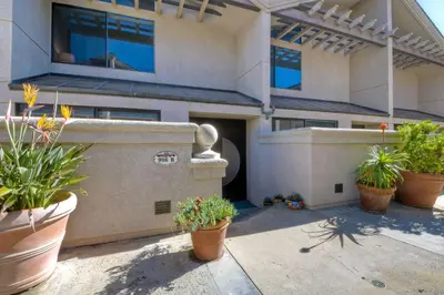 a building with potted plants in front of it at Oceanfront, Luxury Remodel, Pool, Walk To Dining in Encinitas