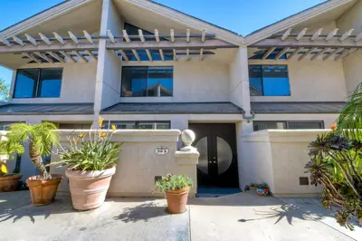 a house with potted plants in front of it at Oceanfront, Luxury Remodel, Pool, Walk To Dining in Encinitas