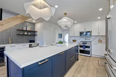 a kitchen with blue cabinets and a white counter top at Oceanfront, Luxury Remodel, Pool, Walk To Dining in Encinitas