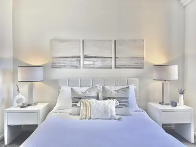 a bedroom with a white bed with two lamps at SPECIAL OFFER - Modern Apartment in La Jolla UTC - Close to Beaches, Shopping, Dining, UCSD in San Diego