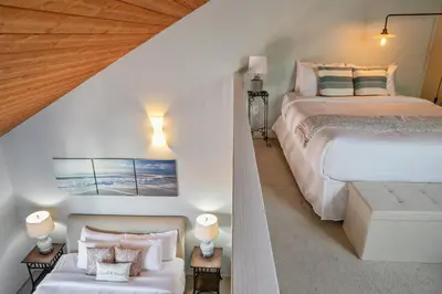 a white bedroom with a bed and a couch at IB Coastal Condo - Imperial Beach - Shops - Patio in Imperial Beach