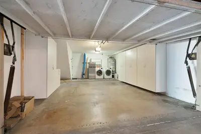 an empty garage with washers and dryers in it at IB Coastal Condo - Imperial Beach - Shops - Patio in Imperial Beach