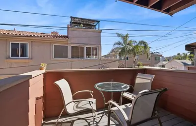 a patio with chairs and a table on a balcony at IB Coastal Condo - Imperial Beach - Shops - Patio in Imperial Beach