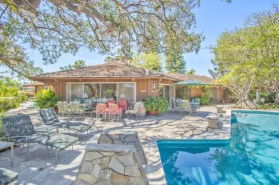 a home with a swimming pool and a patio with chairs at Nature lovers wellness home in Fallbrook