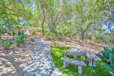 a picnic table in a park with trees at Nature lovers wellness home in Fallbrook
