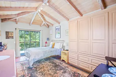 a bedroom with a bed and a large window at Nature lovers wellness home in Fallbrook