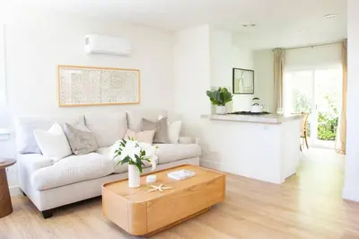 a living room with a couch and a coffee table at Live the Beach Life in a Quaint Shell Cottage in Del Mar