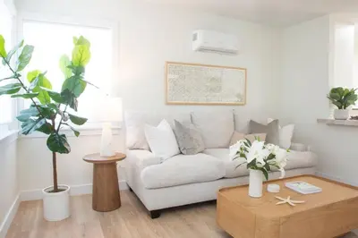 a living room with a couch and a coffee table at Live the Beach Life in a Quaint Shell Cottage in Del Mar