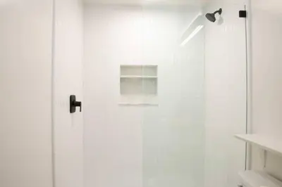 a shower with a glass door in a bathroom at Geometric Loft: renovated, hip, pets, pool/spa in Solana Beach