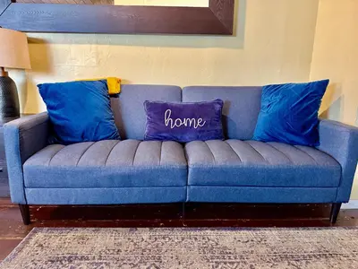 a blue couch with two blue pillows on it at Sunset Haven: Lakeside Charm in Ocean Beach in San Diego