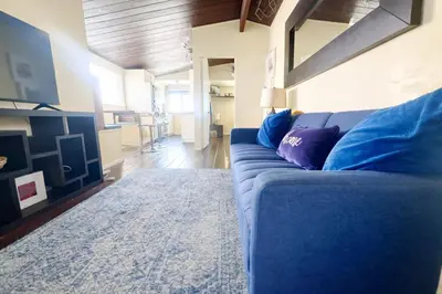 a blue couch sitting in a living room at Sunset Haven: Lakeside Charm in Ocean Beach in San Diego