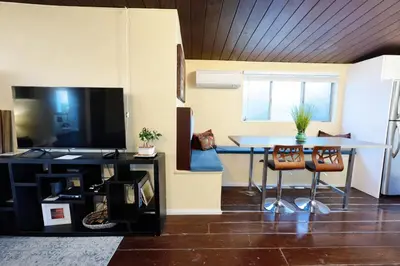 a living room with a table and a dining room at Sunset Haven: Lakeside Charm in Ocean Beach in San Diego