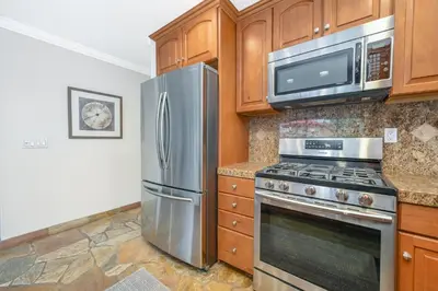 a kitchen with a stainless steel refrigerator and microwave at Three Bedroom Home on 36th with Indoor Outdoor Living in Newport Beach