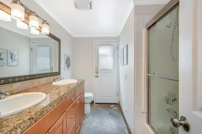 a bathroom with two sinks and a shower at Three Bedroom Home on 36th with Indoor Outdoor Living in Newport Beach