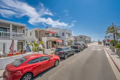 a red car parked on the side of a street at Three Bedroom Home on 36th with Indoor Outdoor Living in Newport Beach