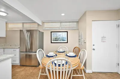 a kitchen and dining room with a table and chairs at Three Bedroom Three Bath Home w Patio 1 block from beach in Newport Beach