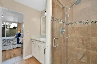 a bathroom with a shower and a sink at Three Bedroom Three Bath Home w Patio 1 block from beach in Newport Beach