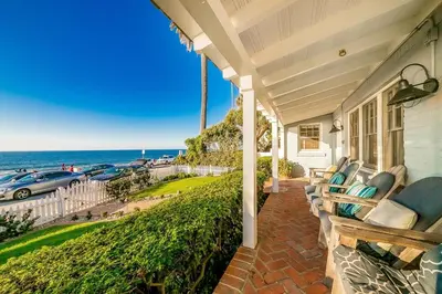 a porch of a house with a view of the ocean at Oceanfront Dog Friendly Home with Waterfront Porch, Gas Grill, Hot Tub & Fire Pit in San Diego