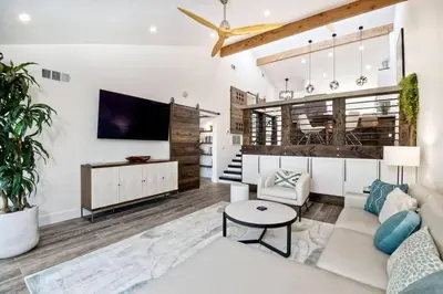 a living room with a couch and a tv at Sea Bluff Beach Home in Encinitas