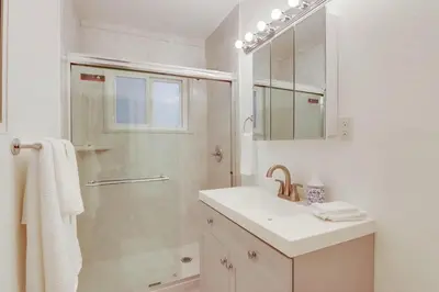 a white bathroom with a sink and a shower at Bayside 1 in San Diego