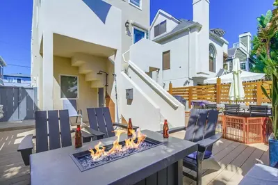 a patio with a table and chairs with a fire pit at Contempo Coastal in San Diego