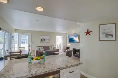 a kitchen and living room with a table and a living room at Contempo Coastal in San Diego