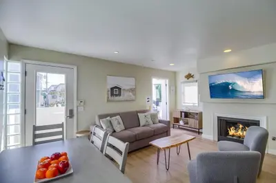a living room with a couch and a fireplace at Contempo Coastal in San Diego