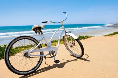 a bike parked on the beach near the ocean at Waterfront 1 in San Diego
