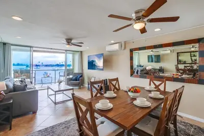 a dining room and living room with a table and chairs at Waterfront 1 in San Diego