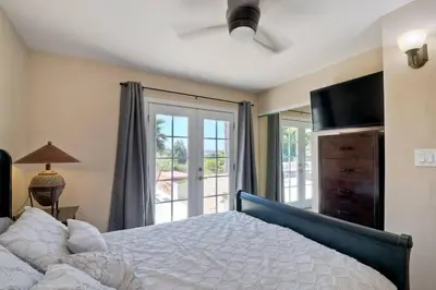 a bedroom with a bed and a sliding glass door at Nice home, Ocean views, and open space views. in Oceanside