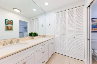 a bathroom with two sinks and a large mirror at SB-503 - Cali Surfer Lounge in Solana Beach