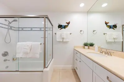 a white bathroom with a shower and a sink at SB-503 - Cali Surfer Lounge in Solana Beach