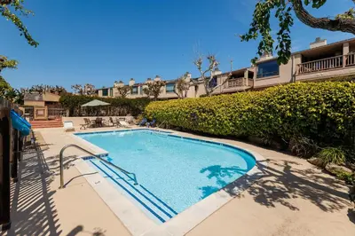 a swimming pool in front of a building at SB-503 - Cali Surfer Lounge in Solana Beach