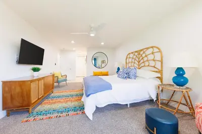 a bedroom with a bed and a flat screen tv at SB-503 - Cali Surfer Lounge in Solana Beach