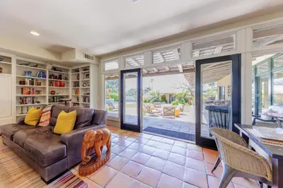 a living room with a brown couch and a table at SB-316 - Sunset Hacienda in Solana Beach
