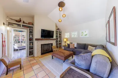 a living room with a couch and a fireplace at SB-316 - Sunset Hacienda in Solana Beach