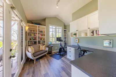 a kitchen with a couch and a chair in a room at SB-316 - Sunset Hacienda in Solana Beach