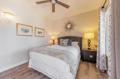 a bedroom with a bed and a ceiling fan at SB-316 - Sunset Hacienda in Solana Beach