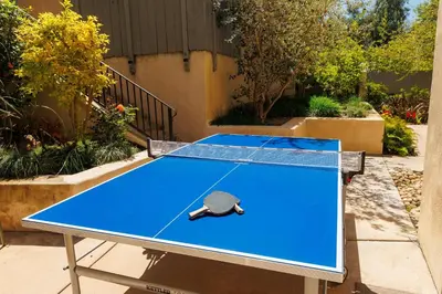 a ping pong table with a tennis racket on it at SB-316 - Sunset Hacienda in Solana Beach