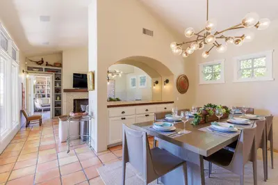 a kitchen and dining room with a table and chairs at SB-316 - Sunset Hacienda in Solana Beach