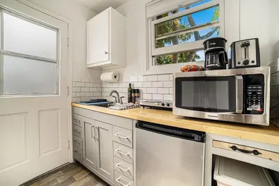 a kitchen with a sink and a microwave at Cozy Studio with Outdoor Oasis in Bonita