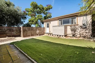 a yard with a fence and a house at Cozy Studio with Outdoor Oasis in Bonita