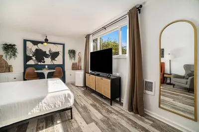 a bedroom with a bed and a flat screen tv at Cozy Studio with Outdoor Oasis in Bonita