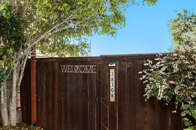 a wooden fence with a welcome home sign on it at Cozy Studio with Outdoor Oasis in Bonita