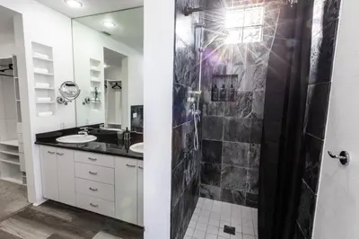 a bathroom with two sinks and a shower at Elite Retreat! Hot Tub, Arcade, & Theater. 6 Beds! in Encinitas
