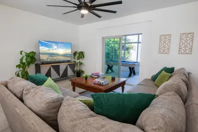 a living room with a couch and a table at Elite Retreat! Hot Tub, Arcade, & Theater. 6 Beds! in Encinitas